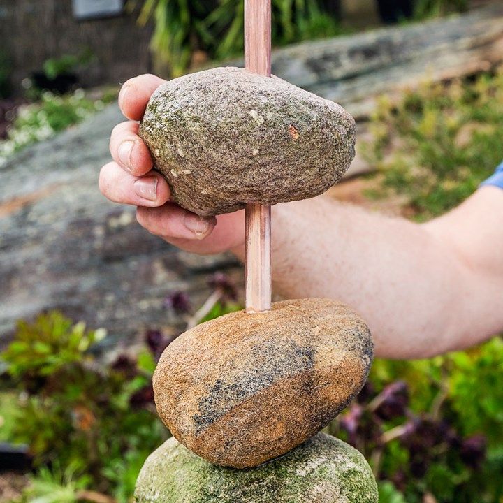 a person is stacking rocks on top of each other in order to balance them