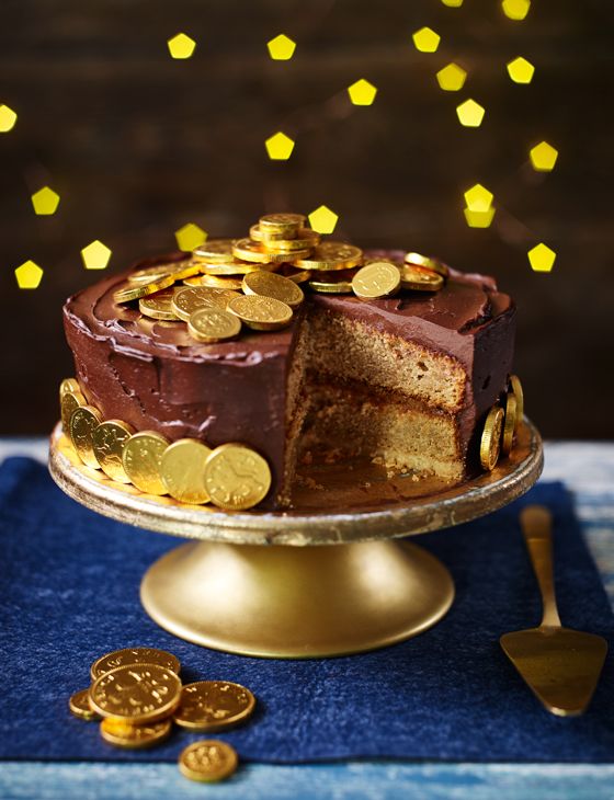 a chocolate cake with gold coins on top