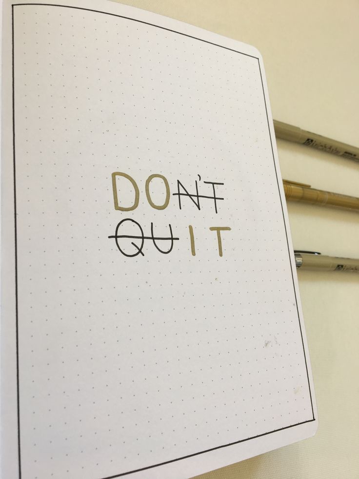 an open notebook with the words don't quit on it