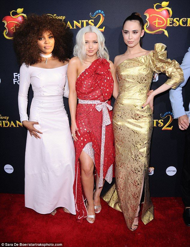 three women standing next to each other on a red carpet at the disney 2 premiere