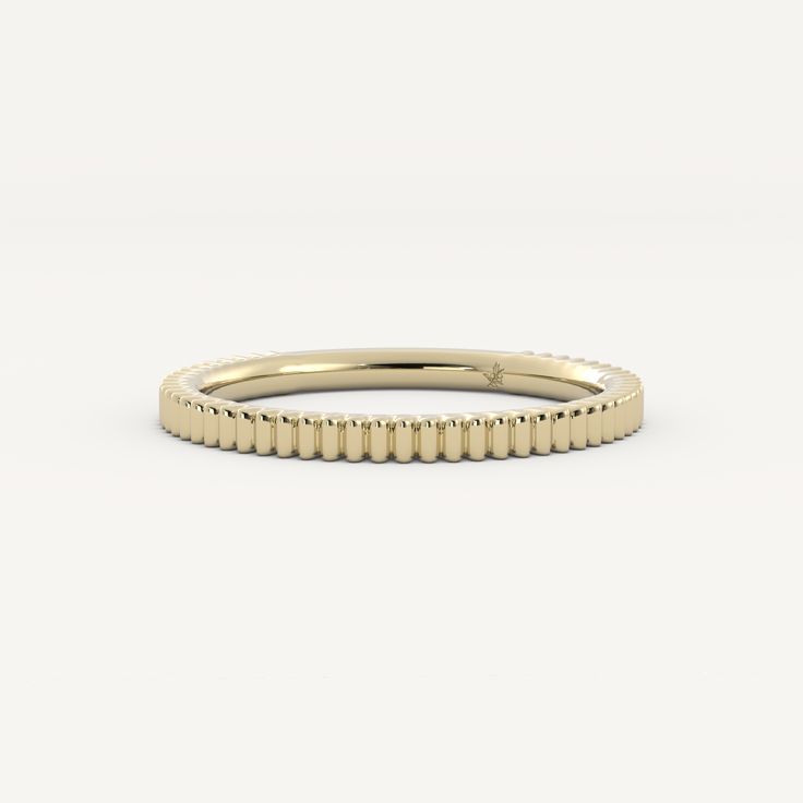 a yellow gold band with rows of beads on the outside and inside, set against a white background