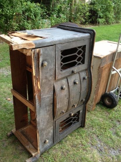 an old wooden stove sitting in the grass