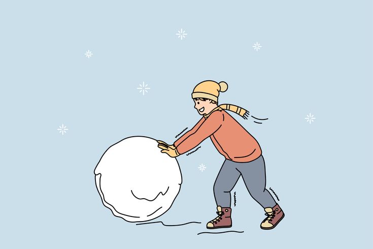 a woman pushing a large snowball down the street