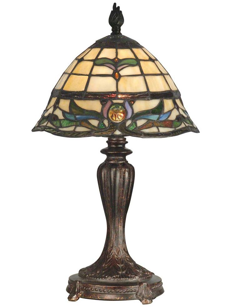 a table lamp with a stained glass shade on it's base and an ornate design