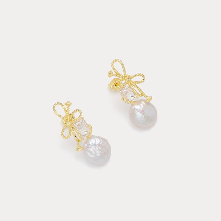 DETAILS Plating: 18K Gold  Materials: 18K Gold on Silver, Baroque Pearl, Cubic Zirconia Size: 1.18"* 0.47 "(3.0cm*1.2cm) Weight: 5.0g/pr Gold Feminine Pearl Earrings For Party, Feminine Gold Pearl Earrings For Party, Elegant Baroque Pearl Earrings For Party, Feminine Gold Pearl Earrings For Gift, Feminine Gold Pearl Earrings, Feminine Gold Pearl Earrings For Anniversary, Gold Pearl Earrings With Bow For Gift, Gold Pearl Earrings With Bow As Gift, Gold Feminine Pearl Earrings For Formal Occasions