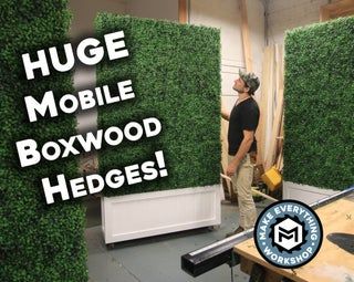 a man standing next to a boxwood hedge in a room with the words huge mobile boxwood hedges