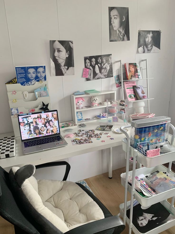 a desk with a laptop computer on top of it next to a chair and other items