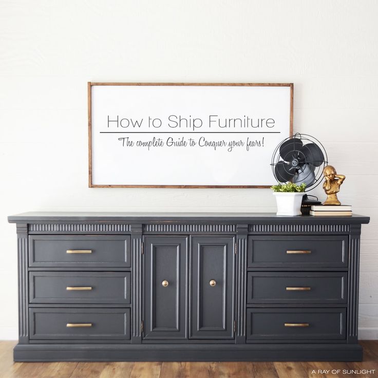 a black dresser with gold handles and drawers in front of a sign that says how to ship furniture