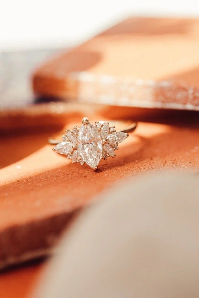 a diamond ring sitting on top of a wooden table