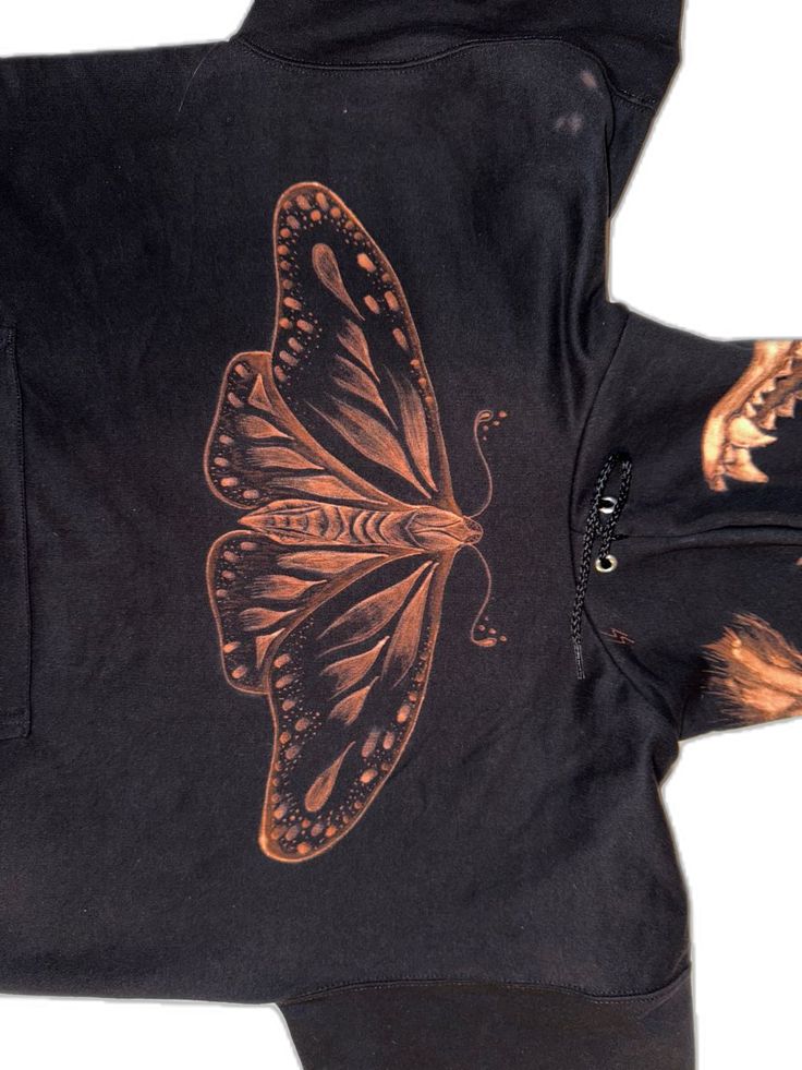 a black jacket with an orange butterfly on it