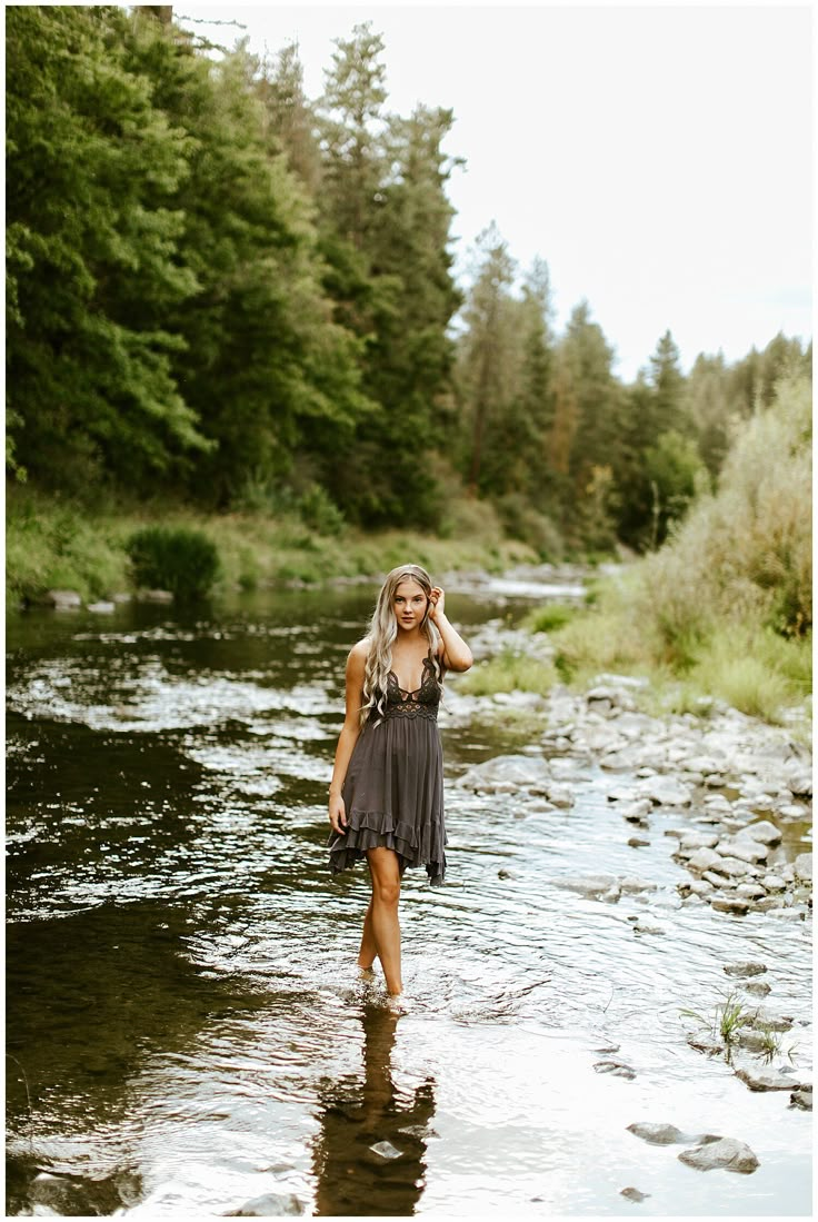 a woman standing in the middle of a river