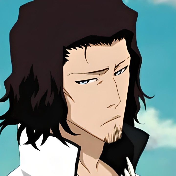 a man with long hair and blue eyes stares into the distance while standing in front of clouds