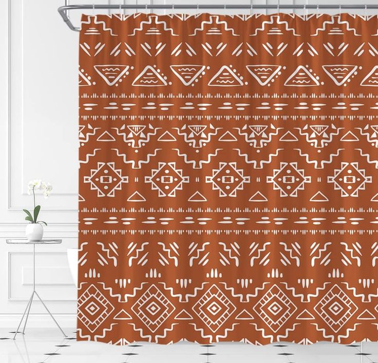 a shower curtain with an orange and white pattern