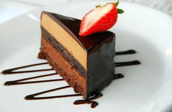 a piece of chocolate cake with a strawberry on top