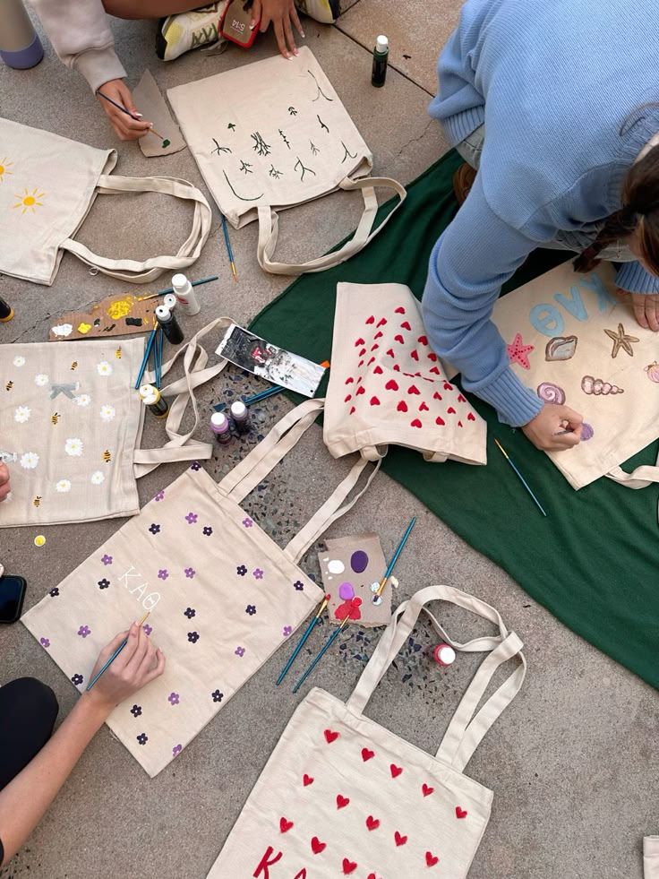 several children are doing arts and crafts on the floor with their teacher's bags