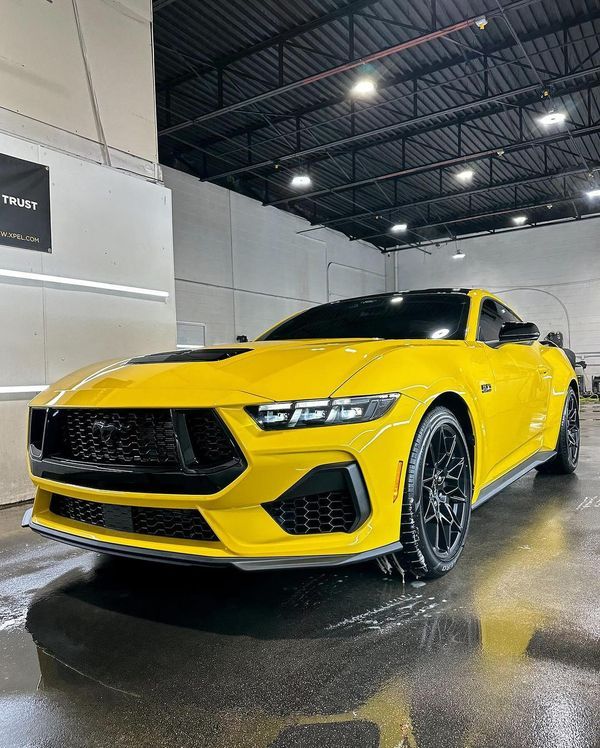 a yellow sports car parked in a garage