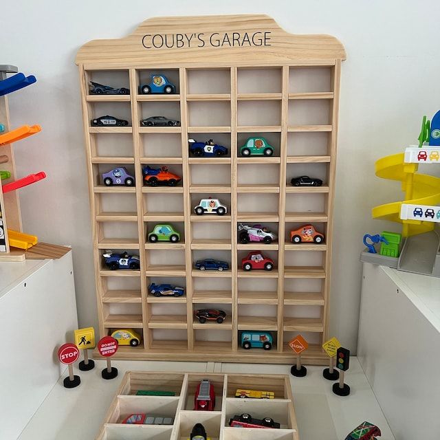 toy cars and trucks are stored in the cubby's garage