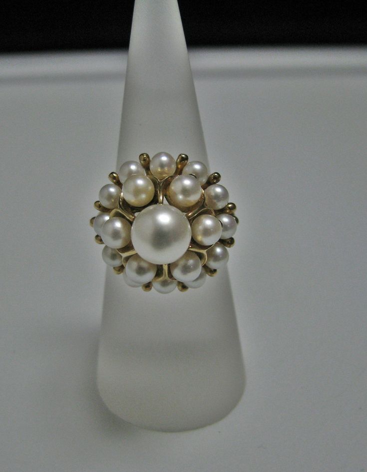 "For Sale is: (1) H077 Stunning Coctail (19) Pearl Ring in 14k Yellow Gold Please Read ENTIRE DESCRIPTION BEFORE PURCHASING This beautiful ring features cocktail ring with multiple (19) pearls in different size. Ring stamped 14k and it is size 5.5 This is a very elegant ring! Cosmetic Condition: This ring is in good condition. A few minor scratches due to age. AS SEEN IN PICTURE: Specifications: *14K Yellow Gold *Cocktail Style *Pearls (12) are approx. 3.4 mm (at the bottom of the ring) *Pearls Formal White 14k Gold Pearl Ring, Classic Evening Rings With Prong Setting, Classic Rings With Prong Setting For Evening, White 14k Gold Jewelry For Evening, Stamped 14k Fine Jewelry Cluster Ring, Fine Jewelry Hallmarked Rings For Party, White Cluster Ring Stamped 14k, Fine Jewelry Party Rings Hallmarked, Estate White Gold Jewelry As A Gift