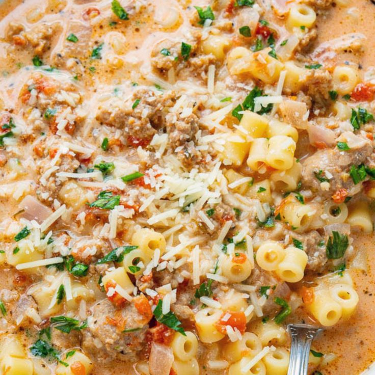 a white bowl filled with pasta and meat