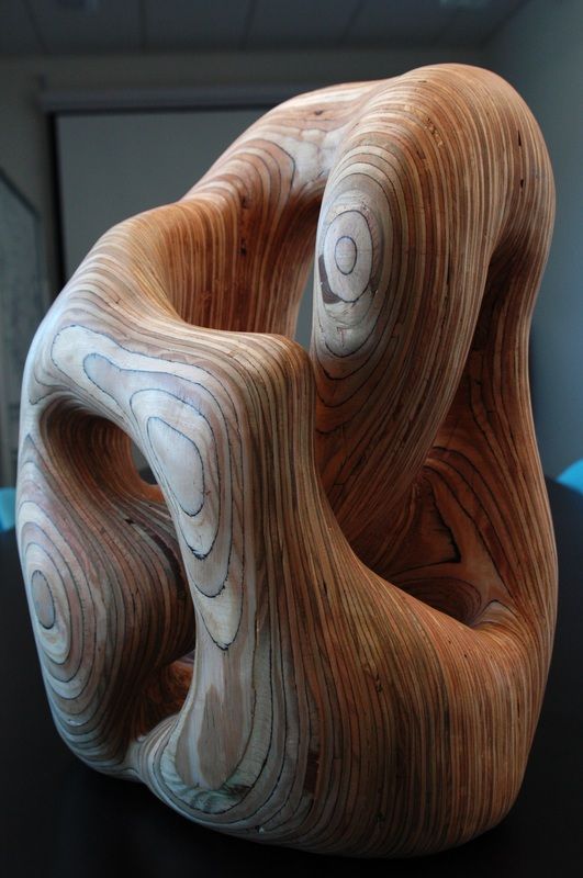 a wooden sculpture sitting on top of a table