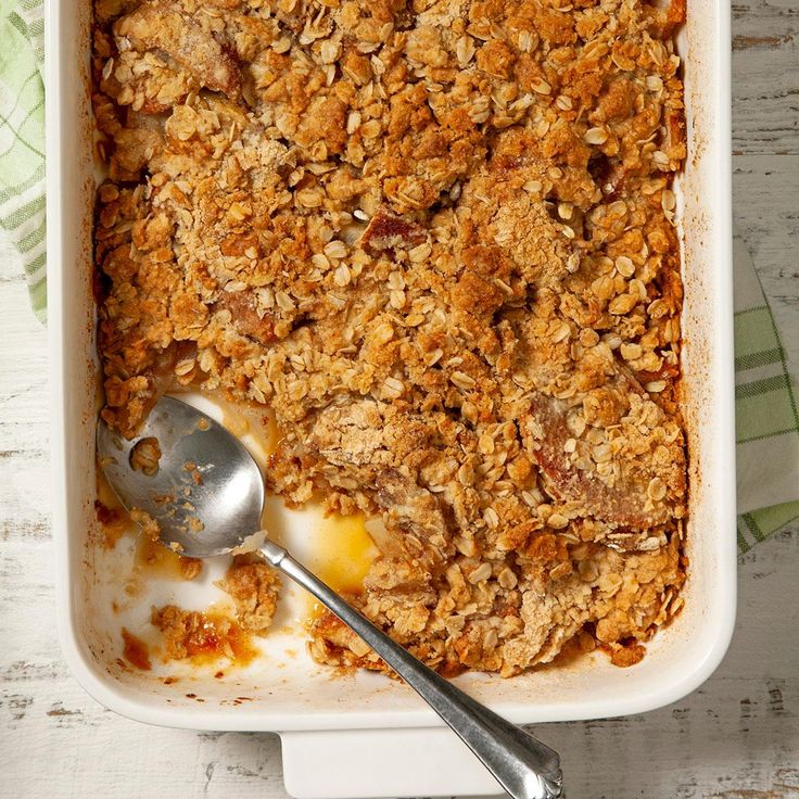 a casserole dish filled with oatmeal and topped with a spoon