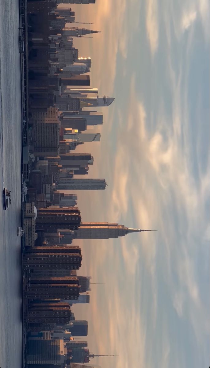 an aerial view of the empire building in new york city, with clouds and blue sky