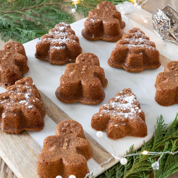 gingerbread cookies are arranged on a cutting board