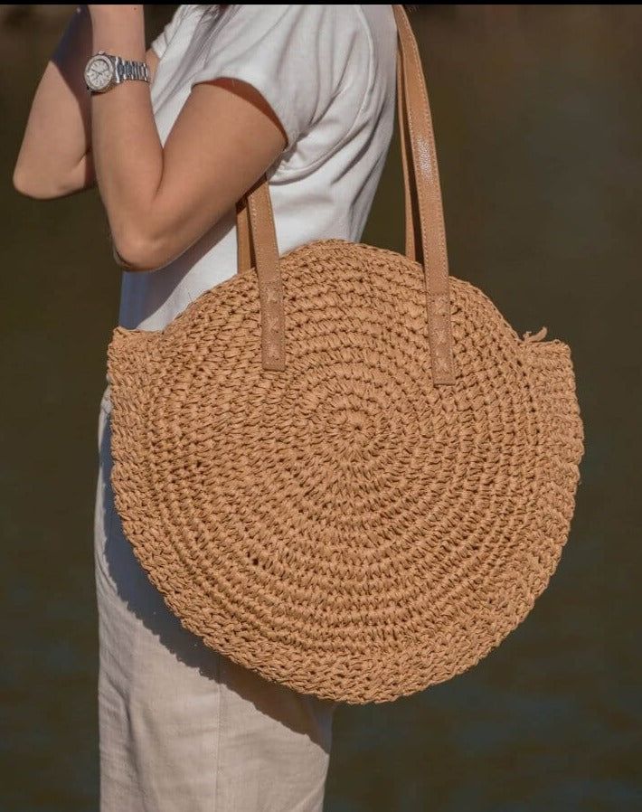 Introducing our Round Straw Bag - the epitome of boho chic and beach vibes. This rattan beach tote bag, also known as the Bali Bag, is the perfect accessory to elevate your style and bring a touch of bohemian charm to any outfit. Shape and Style: The bag's round shape adds a unique and trendy element to your look, making it a standout piece wherever you go. Its boho-inspired design is perfect for beach days, vacations, or casual outings, giving you that relaxed and carefree feel. Versatile Shoul Chic Summer Bags Made Of Natural Fiber, Chic Beach Bag Made Of Natural Fiber, Chic Summer Straw Bag For Everyday, Everyday Summer Straw Shoulder Bag, Summer Everyday Straw Bags, Chic Everyday Summer Straw Bag, Summer Beach Bag With Braided Handles For Everyday, Adjustable Strap Beach Bag Made Of Natural Fiber, Trendy Straw Bag For Everyday Beach Use