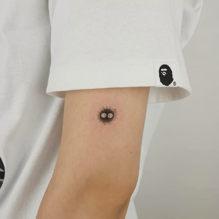 a person with a black and white tattoo on their arm