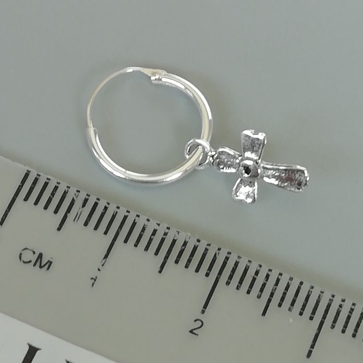 Comes with a detachable cross charm. The charm is multipurpose and can be used with a neck or bracelet chain too. Dimension: Hoop- 12 x 1.2 mm Cross: 7 x 12 mm Weight: 0.70gm Price listed is for a PAIR of hoops. These earrings are made of 925 hypoallergenic sterling silver and comes with a 925 stamp. Can be packaged in a gift box. I can include a personal message from you if needed You are welcome to contact me at... bhavnakwintra1956@gmail.com For more beautiful pieces from my shop, please brow Nickel Free Silver Huggie, Adjustable Small Hoop Earrings Nickel Free, Silver Nickel-free Huggie Hoop Earrings, Nickel-free Silver Huggie Earrings, Silver Hypoallergenic Dangle Hoop Earrings, Hypoallergenic Silver Dangle Hoop Earrings, Nickel-free Small Hoop Huggie Earrings In White Gold, Silver Adjustable Small Hoop Jewelry, Nickel-free Silver Dangle Huggie Earrings