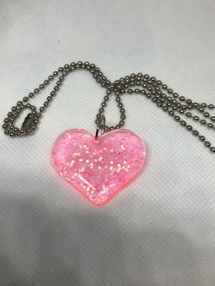 The chain is a little long. Heart is a see though pink color along with some cute glitter. Cute Pink Jewelry With Chain Detail, Cute Pink Jewelry With Chain, Valentine's Day Clear Jewelry For Party, Pink Heart Pendant Jewelry For Party, Pink Glitter Jewelry For Valentine's Day, Cute Clear Jewelry For Party, Pink Glitter Jewelry For Gift, Cute Clear Party Jewelry, Valentine's Day Pink Glitter Jewelry