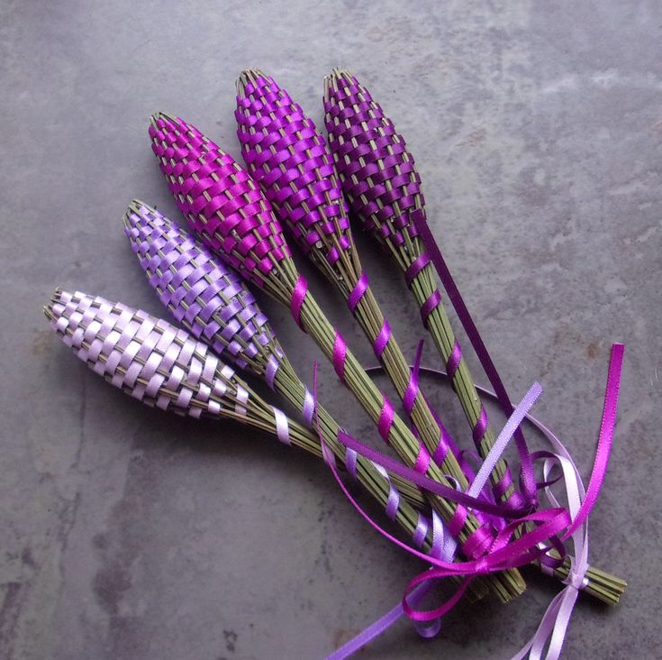 purple flowers are tied together on a gray surface