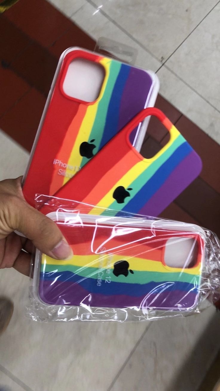 someone is holding up their iphone cases with the same colors as they are in plastic