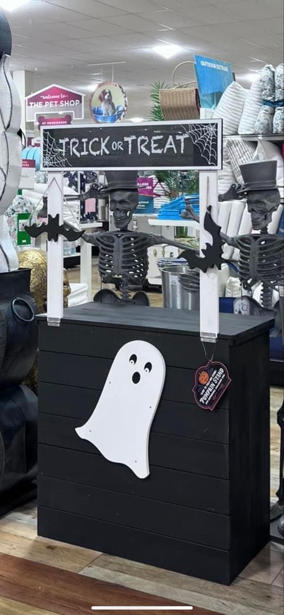 a black trunk with white ghost decorations on it and a sign that says trick or treat