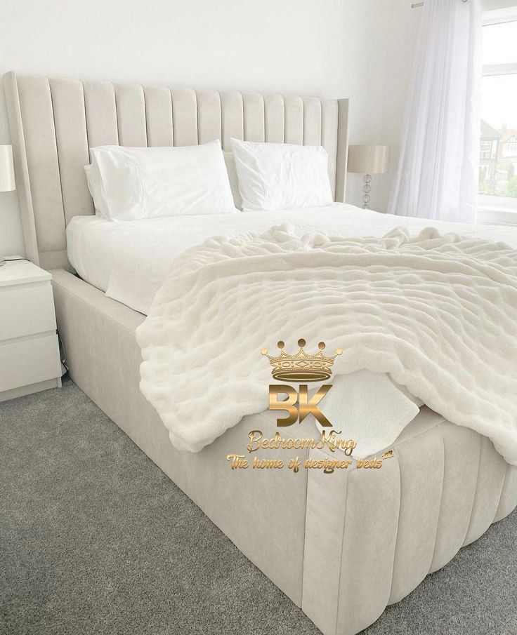 a large bed with white sheets and pillows