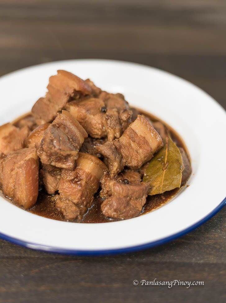 a white plate topped with meat and vegetables