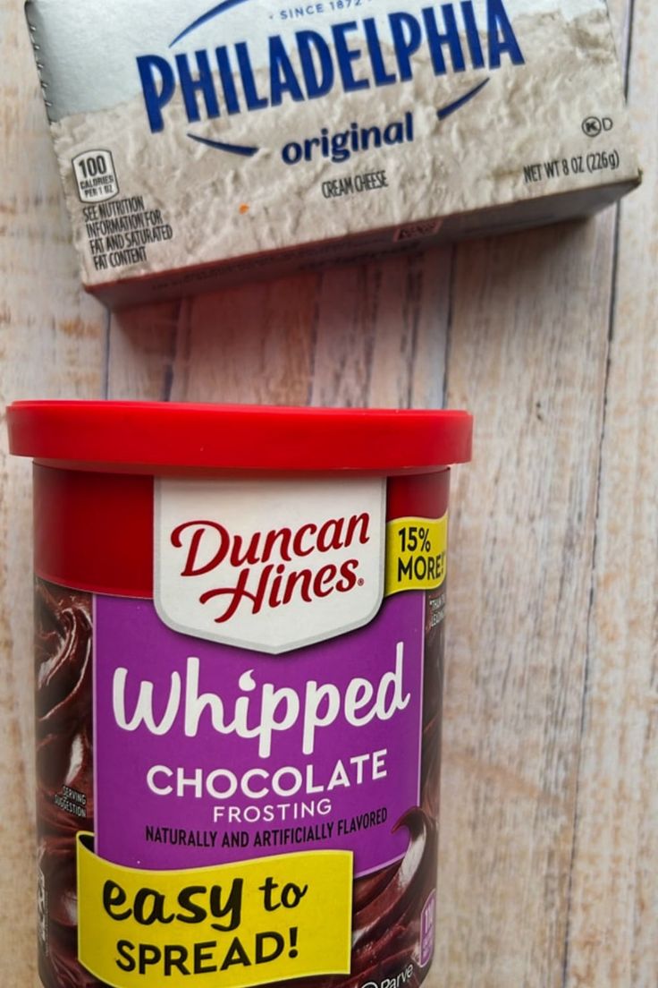 two containers of whipped chocolate next to each other