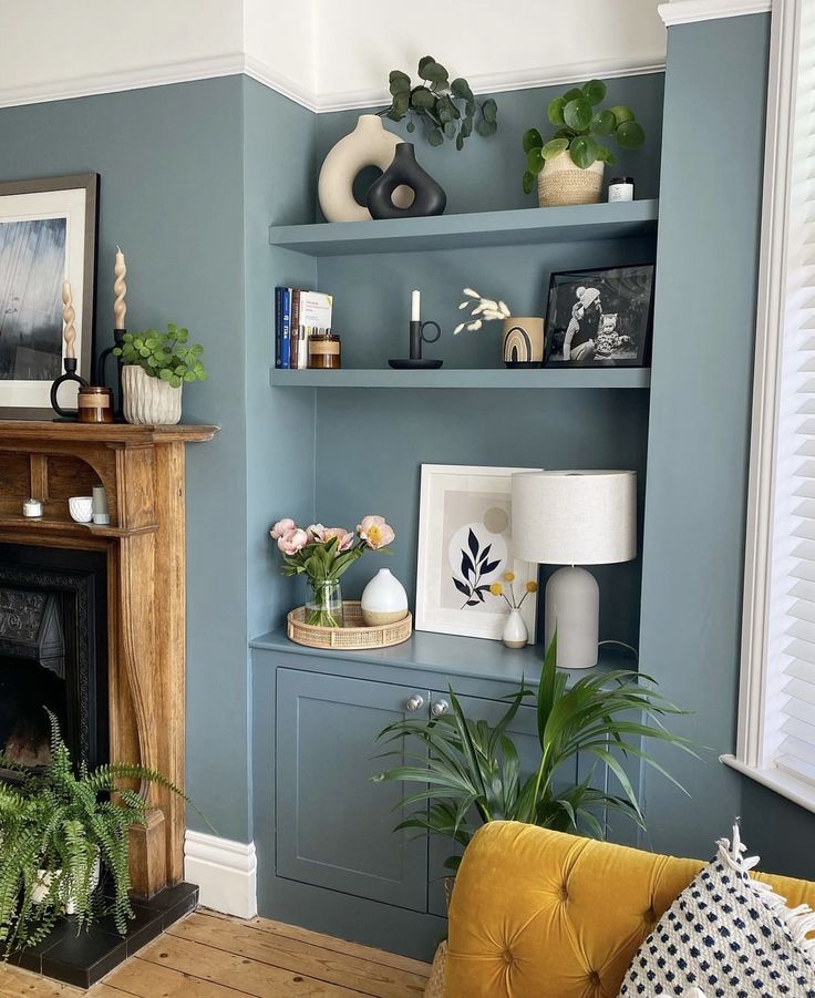 a living room filled with furniture and a fire place covered in plants next to a fireplace