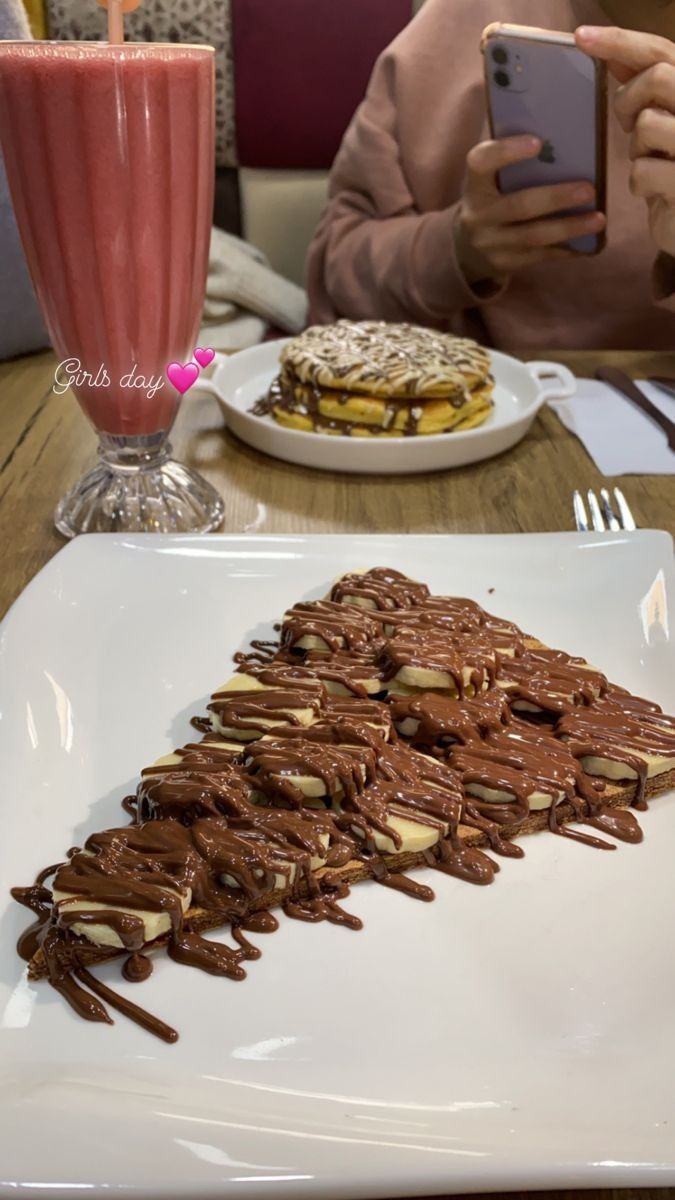 a white plate topped with chocolate covered desserts next to a tall glass of milk