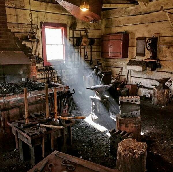 the inside of an old wooden building with lots of tools in it and sunlight coming through the window