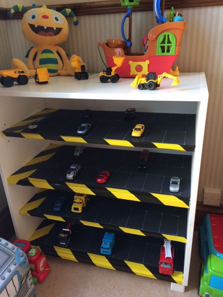 a toy shelf with cars and trucks on it