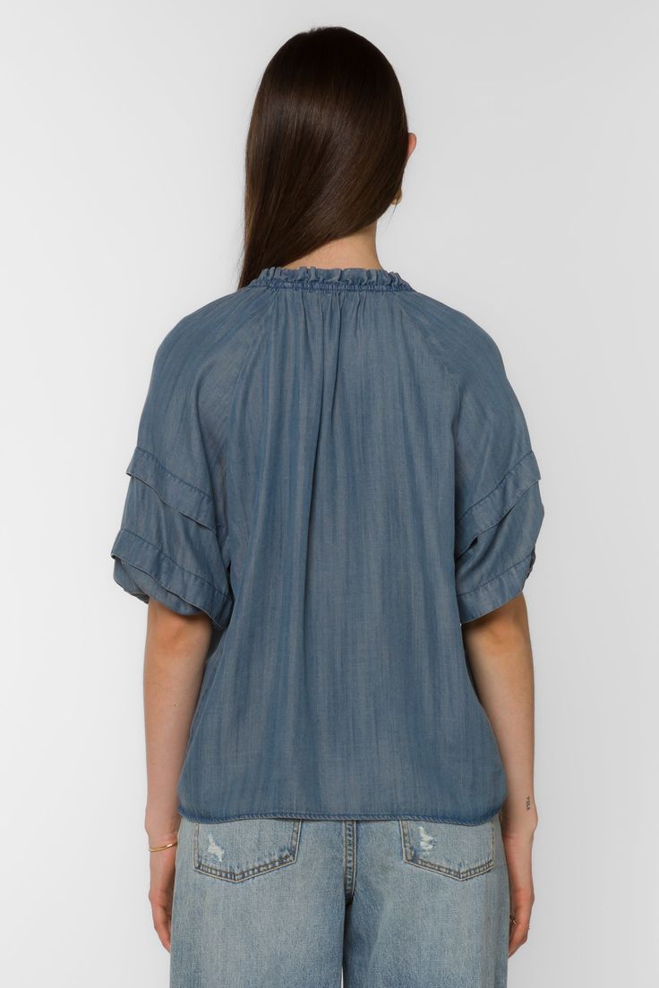 The Kenna Blouse offers an elegant style with its smocked neck, pleated elbow puff sleeve, and V-neck. It's perfect for dressier occasions, while still remaining comfortable and easy to wear. Material: 100% Tencel™ Eco-Friendly Color: 405 Malibu Machine wash cold or hand wash Model is 5'9" and wearing a size S Imported Spring V-neck Smocked Top With Gathered Sleeves, Casual V-neck Puff Sleeve Top For Daywear, Casual V-neck Peasant Top With Smocked Bodice, Flowy Blouse With Smocked Back, Summer Short Sleeve Peasant Top With Gathered Sleeves, Flowy Puff Sleeve Blouse With Smocked Back, Casual Peasant Top With Elastic Sleeves, Casual Blouse With Smocked Back And Flutter Sleeves, Casual Blouse With Flutter Sleeves And Smocked Back