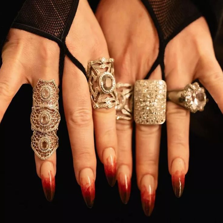 a woman's hand with five rings on it