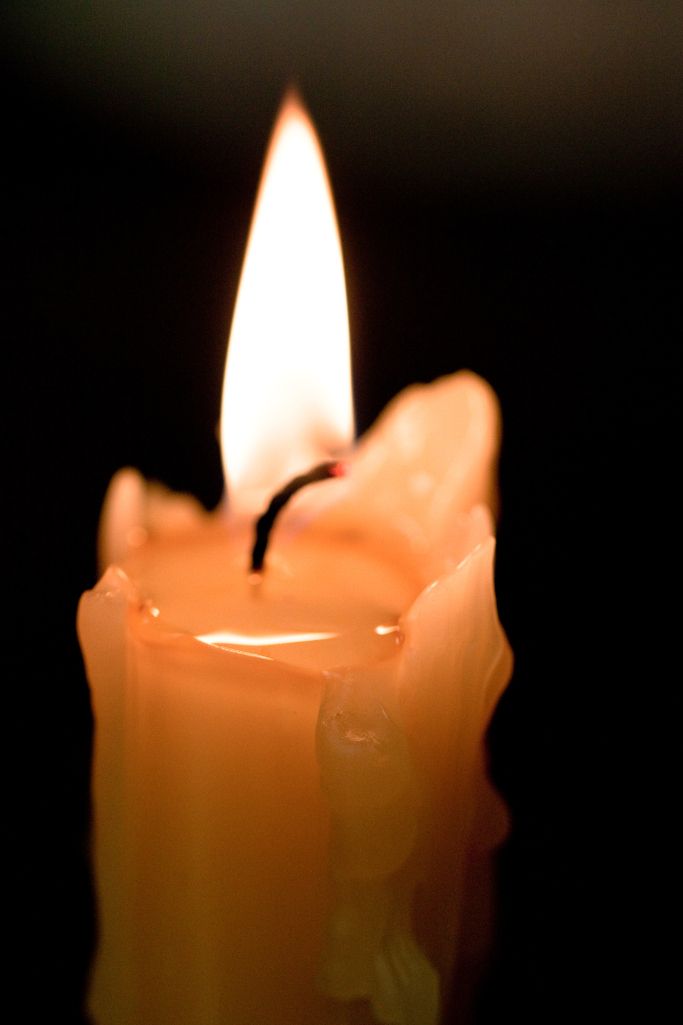 an orange candle with a white light on it