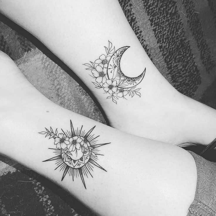 two sun and moon tattoo designs on both legs, one is black and the other is white