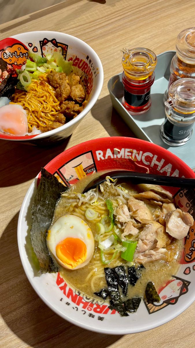 two bowls of ramen with an egg on top