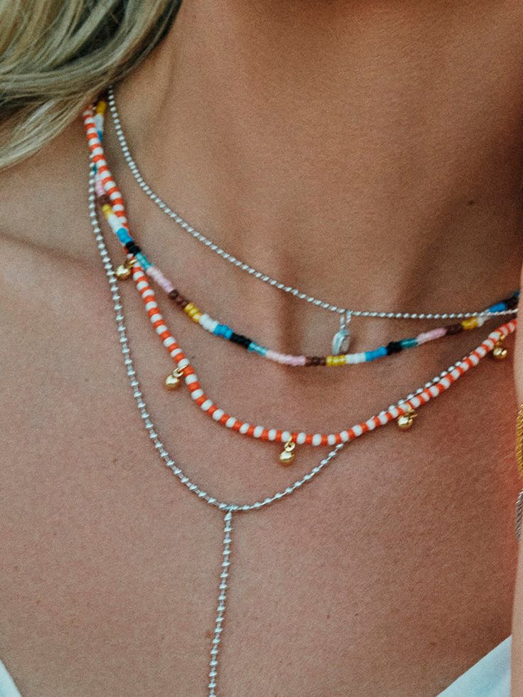 Take a piece of the sunset with you every time you wear this colorful beaded necklace. Crafted with orange and white beads, plus gold dangles, the Sunset Beaded Necklace will effortlessly layer into your beaded or gold summer necklace stacks. Want more beaded necklaces? Shop all of our beaded jewelry. Cheap Orange Beaded Jewelry, Pink And Orange Beaded Necklace, Cheap Playful Beaded Necklaces With Round Beads, Affordable Orange Letter Beads Necklace, Fish Beaded Necklace, Layered Bead Necklaces, Beaded Layered Necklace, Star Beaded Necklace, Beeded Necklace