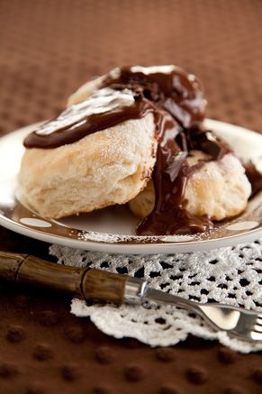 a plate with some chocolate covered doughnuts on it