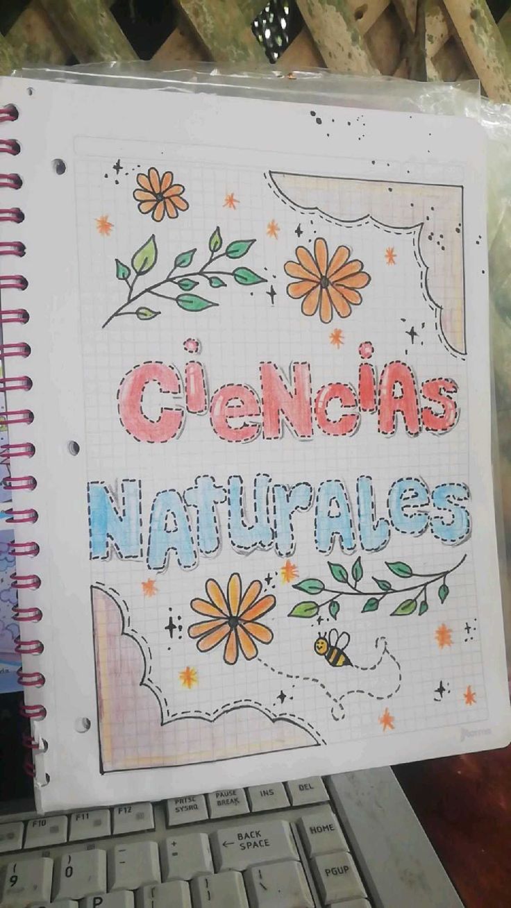 a notebook with the words cienja naturales written on it next to a keyboard