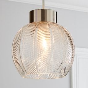 a glass light fixture hanging from a ceiling in a room with white walls and trimmings